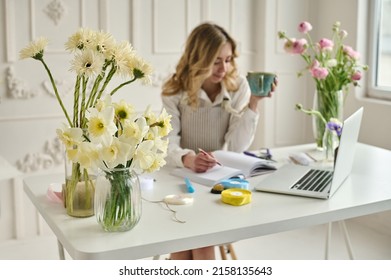 Young Creative Woman In A Flower Shop, Using Laptop. A Startup Of Florist Business.