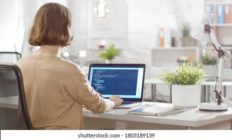 Young Creative Woman Software Developer Writes Code on Her Laptop Computer. She Sits in Her Bright Modern Developers Office.