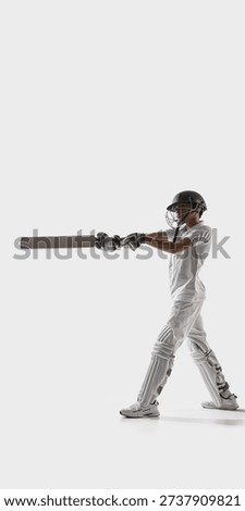 Young cricket batsman executing front foot shot in studio on white background. Concept of cricket technique mastery, youth athletic training program and competitive sports development. Banner