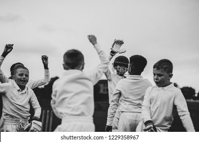 Young cricket players cheering to their victory - Powered by Shutterstock