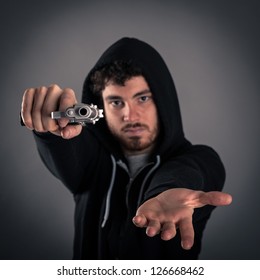 Young Criminal Pointing A Gun While Asking For Money.