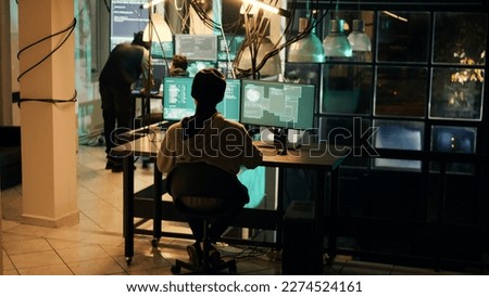 Young criminal using knowledge of technology to access valuable information illegally, breaking into computer system or network. Spy doing cryptojacking and espionage with virus.