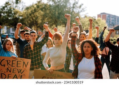 young crowd in protest demonstration - group of activists in march with raised fist - Powered by Shutterstock