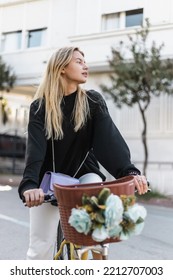 Young Curious Woman In Trendy Outfit Riding Bicycle On Street In Turkey