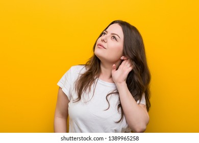 Young curvy plus size woman trying to listening a gossip. - Shutterstock ID 1389965258