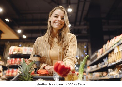 Young customer woman wear casual clothes holding bell pepper shopping at supermaket store grocery shop buying with trolley cart choose products inside hypermarket. Purchasing food gastronomy concept - Powered by Shutterstock