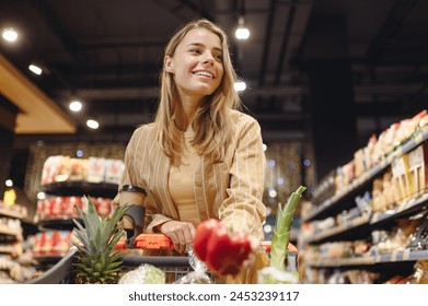 Young customer woman wearing casual clothes hold bell pepper shopping at supermaket store grocery shop buying with trolley cart choose products inside hypermarket. Purchasing food gastronomy concept - Powered by Shutterstock