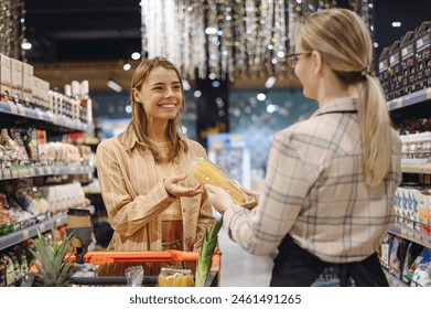 Young customer woman wears casual clothes talk speak with seller shopping at supermaket store grocery shop buying with trolley cart choose products in hypermarket. Purchasing food gastronomy concept - Powered by Shutterstock