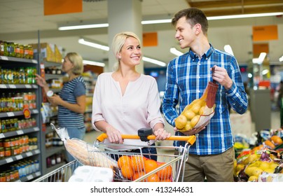 Young customers choosing fresh frusits in food store