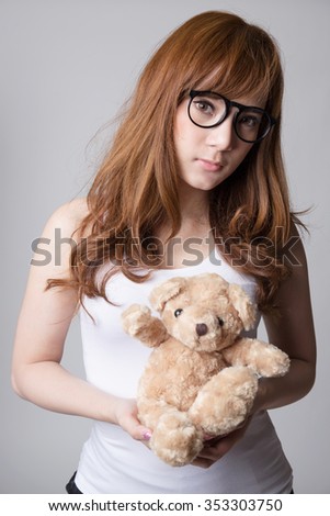 Young cute asian woman  with glasses holding bear doll, Nerd,  loveless or beloved woman concepts,