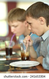 Young Cute Boys Drink Coke In Cafe