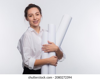Young and cute business woman holds blueprints in her hands. She is happy that her project was approved and she got the job isolated on white copy space