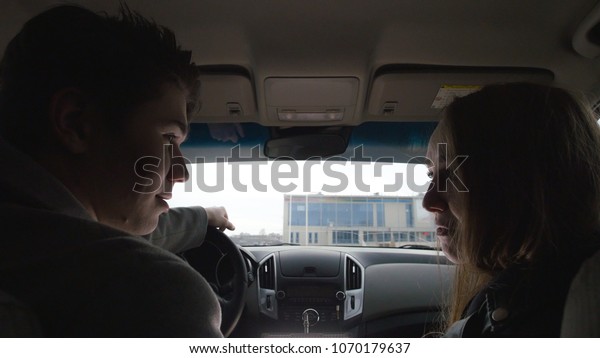 Young cute\
couple hugging and kissing in a\
car