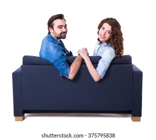 Young Cute Couple Sitting On Sofa Isolated On White Background