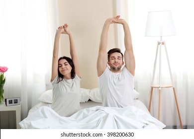 Young Cute Couple Waking Up After A Night Sleep.