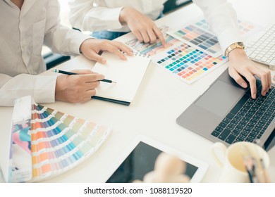 Young Cute Graphic Designer Using Graphics Tablet To Do His Work At Desk