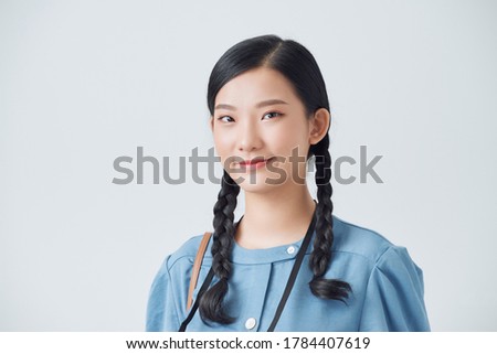 Young cute smiling girl taking pictures on a compact camera