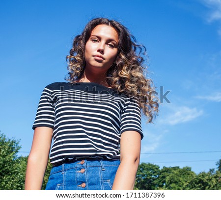 young cute summer girl on green grass outside relaxing smiling close up sunny vacation, lifestyle real people concept