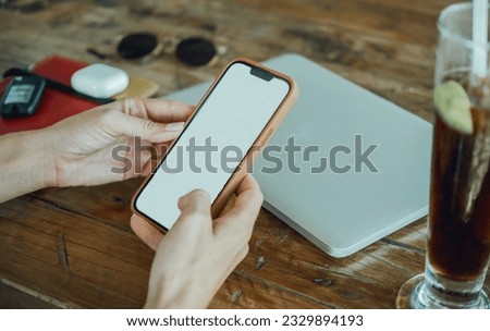 young cute woman using phone,sitting at a cafe holding a smartphone,answering texts,phone calls,letters,posts photos in instagram,outdoor portrait, close up, elaborated and bracelets on the hands Imagine de stoc © 