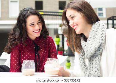 Young Cute Women Laughing While Having A Coffee Outdoors