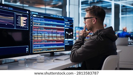 Young Cybersecurity Analyst Monitors Network Threats In Real-time Using Advanced Software Tools.