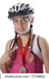 A young cyclist posing with her medal on a white background
