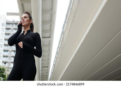 Young Dance Girl In Black Suit Talking On Mobile Phone While Standing In The City