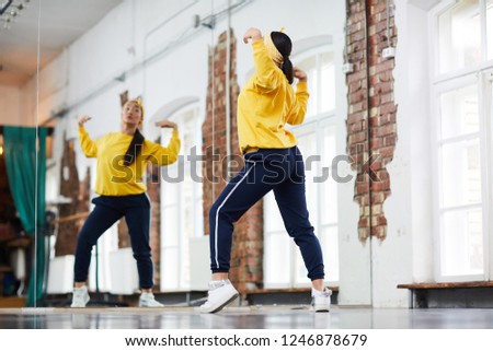 Similar – Image, Stock Photo woman dances in front of the window while listening to music on her headphones
