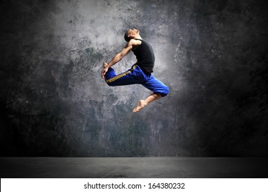  Young dancer is jumping on stage  /Modern urban dance - Powered by Shutterstock