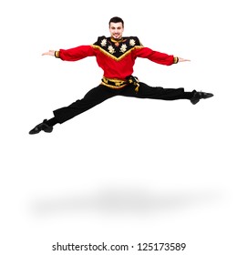 Young Dancer Man Wearing A Folk Russian Costume Jumping Against Isolated White Background