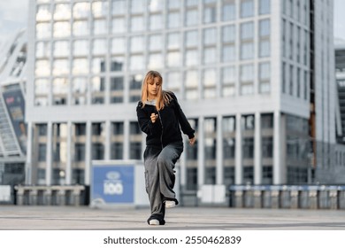 Young dancer performs street dance routine in urban setting during daytime - Powered by Shutterstock