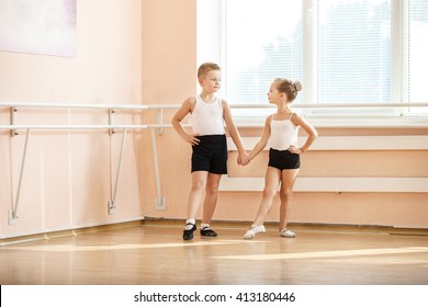 Young dancers doing an exercise while warming up at ballet class