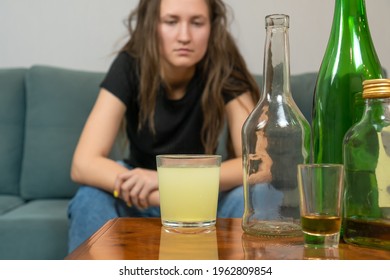 Young Dark-haired Woman With A Hangover Will Drink A Fizzy Pill From Her Head After A Wild Party At Home, Trying To Prepare For The Day Ahead. Concept Of Monday Morning, Morning After Drinking Alcohol