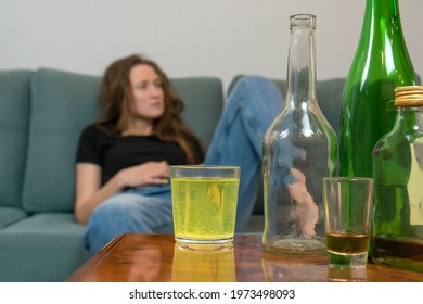 Young Dark-haired Woman With A Hangover Will Drink A Fizzy Pill From Her Head After A Wild Party At Home, Trying To Prepare For The Day Ahead. Concept Of Monday Morning, Morning After Drinking Alcohol