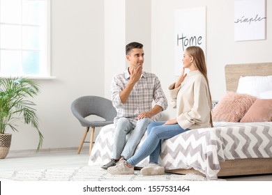 Young deaf mute couple using sign language at home