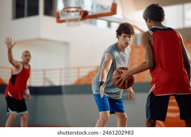 Young defense basketball player inaction during a match.  - Powered by Shutterstock