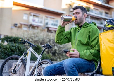 Young Delivery Man Having Rest, Fast Express Delivery Service Worker Drinking Water From His Flask, Sustainability And Ecologic Work In Trasportation Industry, Metal Plastic Free Canteen