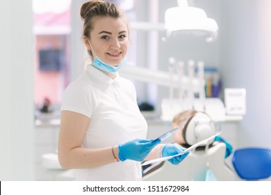 Young dentist in clinic stand in front of equipment and smile - Shutterstock ID 1511672984