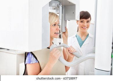 A Young Dentist Taking A Panoramic Digital X-ray Of A Patient`s Teeth