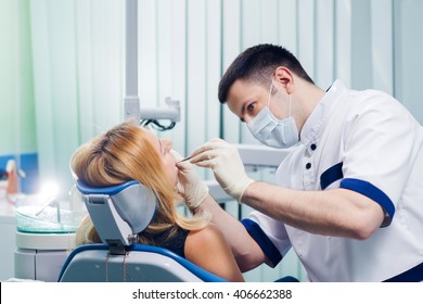 Young Dentist Working With The Female Patient In A Modern Hospital. 