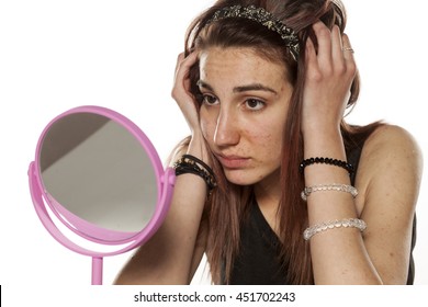 Young Depressed And Sad Girl Looking In The Mirror