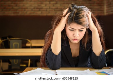 Young Depressed Stressed Frustrated Asian Businesswoman Working At Office Desk