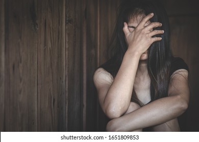 Young depressed woman, domestic and rape violence,beaten and raped sitting in the corner, Domestic violence.