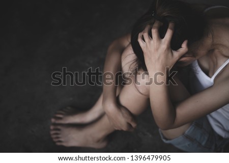 Young depressed woman, domestic and rape violence,beaten and raped sitting in the corner, Domestic violence. Copy space.