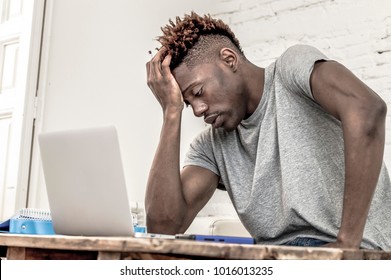 Young Desperate And Overwhelmed Black Afro American Man In Stress At Home Working Stressed With Laptop Computer Worried And Tired In College University Student Preparing Exam Concept