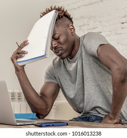 Young Desperate And Overwhelmed Black Afro American Man In Stress At Home Working Stressed With Laptop Computer Worried And Tired In College University Student Preparing Exam Concept