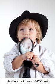 Young Detective With Magnifying Glass, Studio Shot