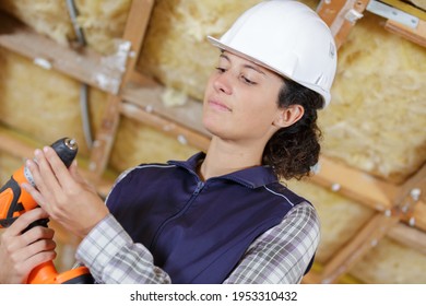 Young Determinated Woman Using Drill