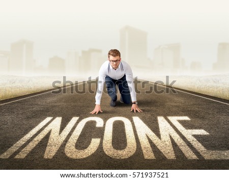 Young determined businessman kneeling before income sign