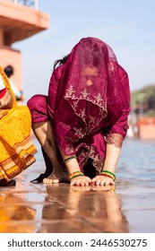 young devotee praying for holy god after bathing in holy river water at morning from flat angle